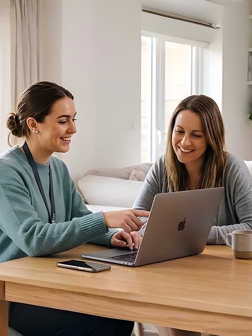 Person using a laptop and phone to contact Culm Forge Media