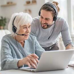 A friendly IT support session helping a client with online safety and tablet basics at home in Devon